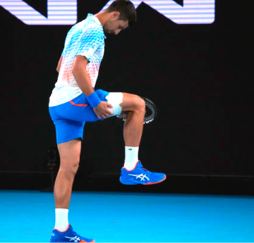 Novak Djokovic struggles with leg injury and heckler during Australian Open win